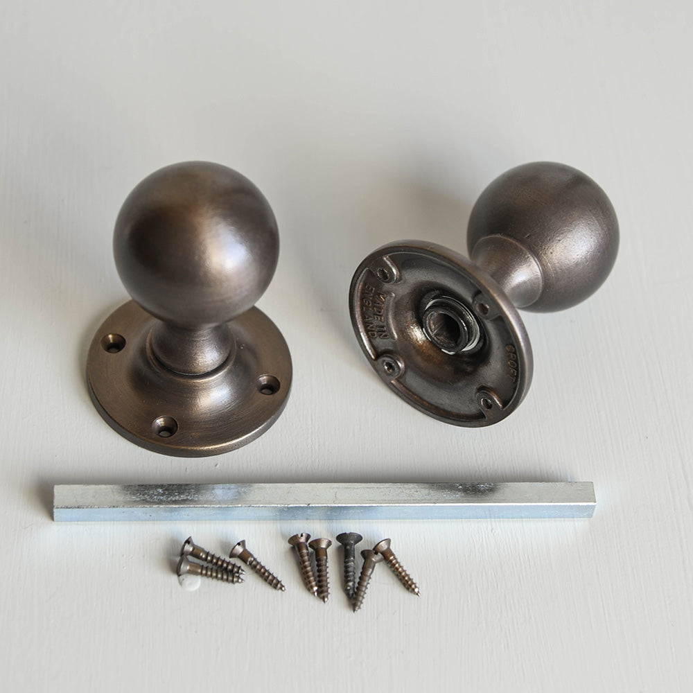 Components of Round Distressed Antique Brass Door Knobs.