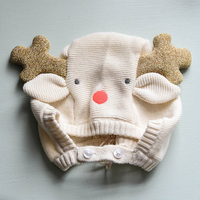 Festive baby bonnet. knitted from organic cotton with knitted floppy ears, gold glitter reindeer antlers, stitched nose and eye details and button fastening under chin