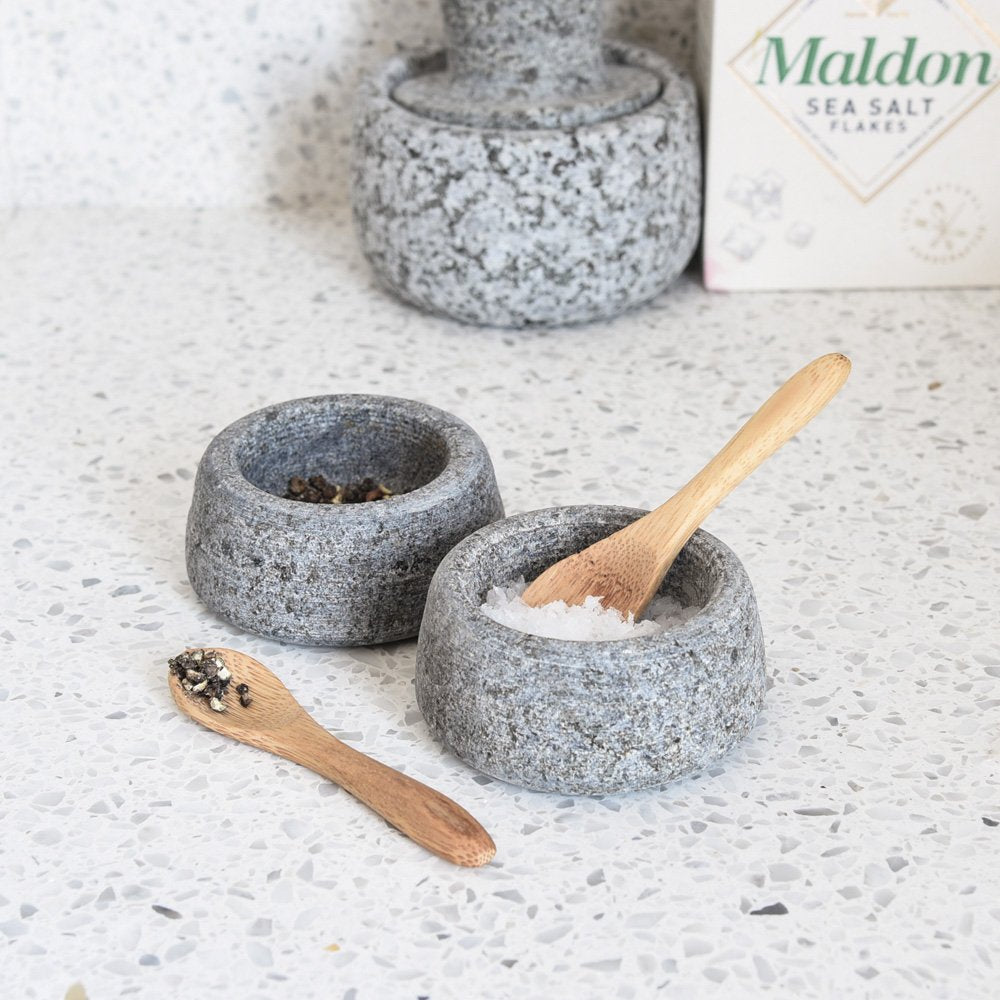 Two granite pots for salt and pepper with two bamboo wooden teaspoons