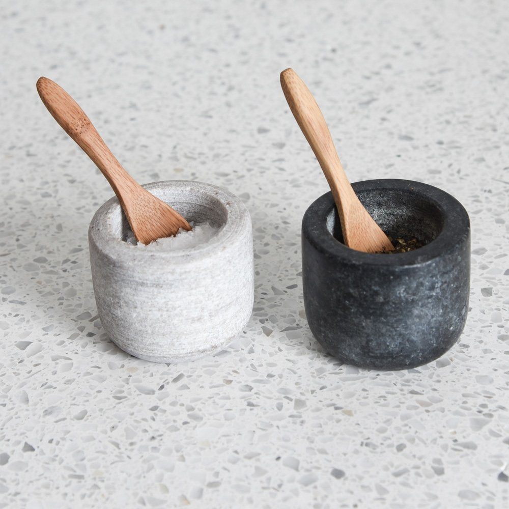 Set of two salt and pepper pots. One dark grey granite pot and one pale grey marble pot. Complete with two bamboo teaspoons.