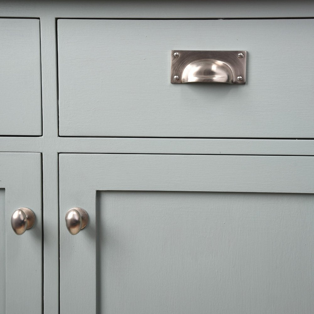 Satin Nickel Hooded Drawer Pull and two Satin Nickel Oval Cabinet Knobs.