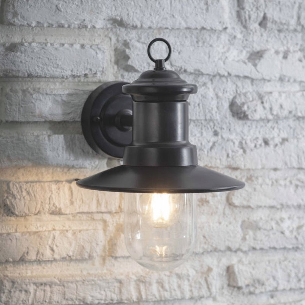 Traditional design ships wall light in dark blue-black finish with clear glass shade