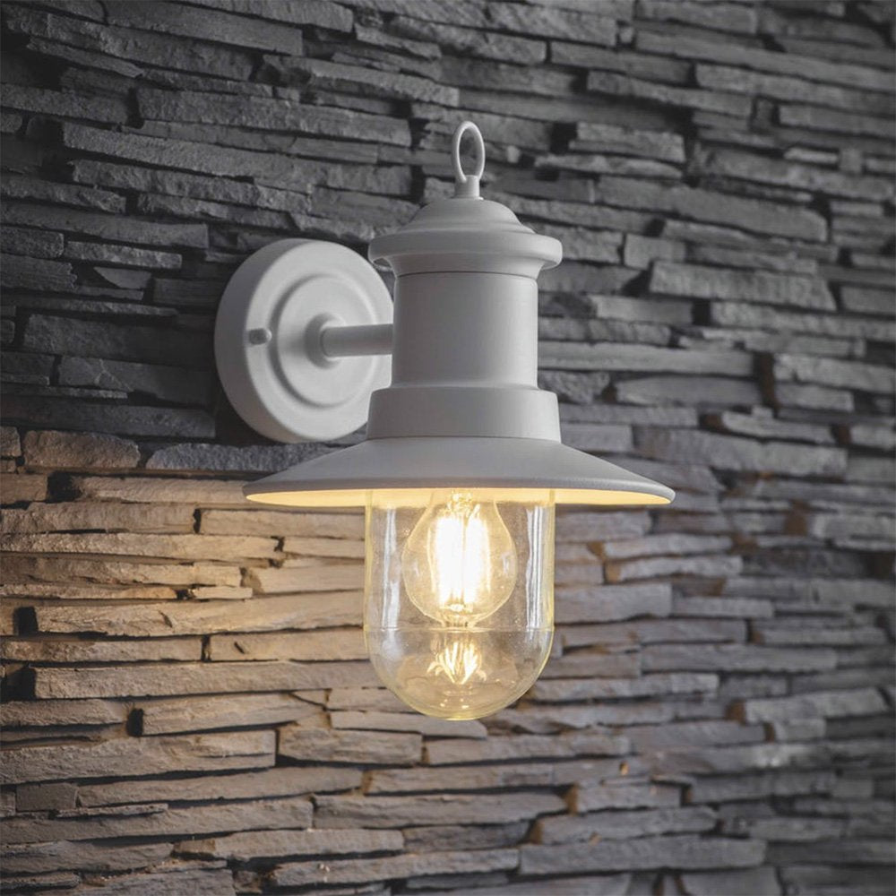 Traditional design ships wall light in lily white finish with clear glass shade