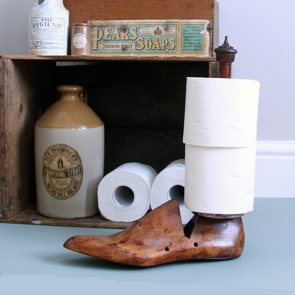 Wooden shoe last toilet roll holder in situ with two stacked toilet rolls. Also suitable to hold one kitchen roll.