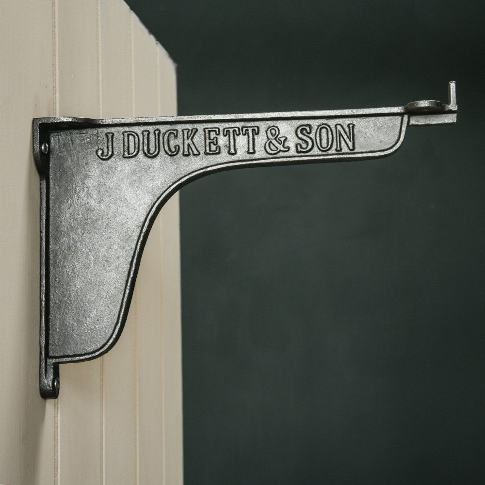 Side View of Simplified Cast Iron Cistern Shelf Bracket with 'J DUCKETT & SON' Text