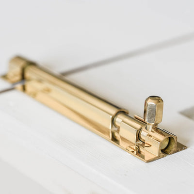 Solid brass Rounded Barrel Bolt on cupboard door.