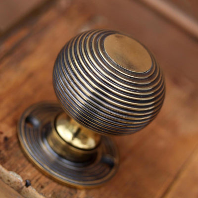 Aged brass beehive door knob