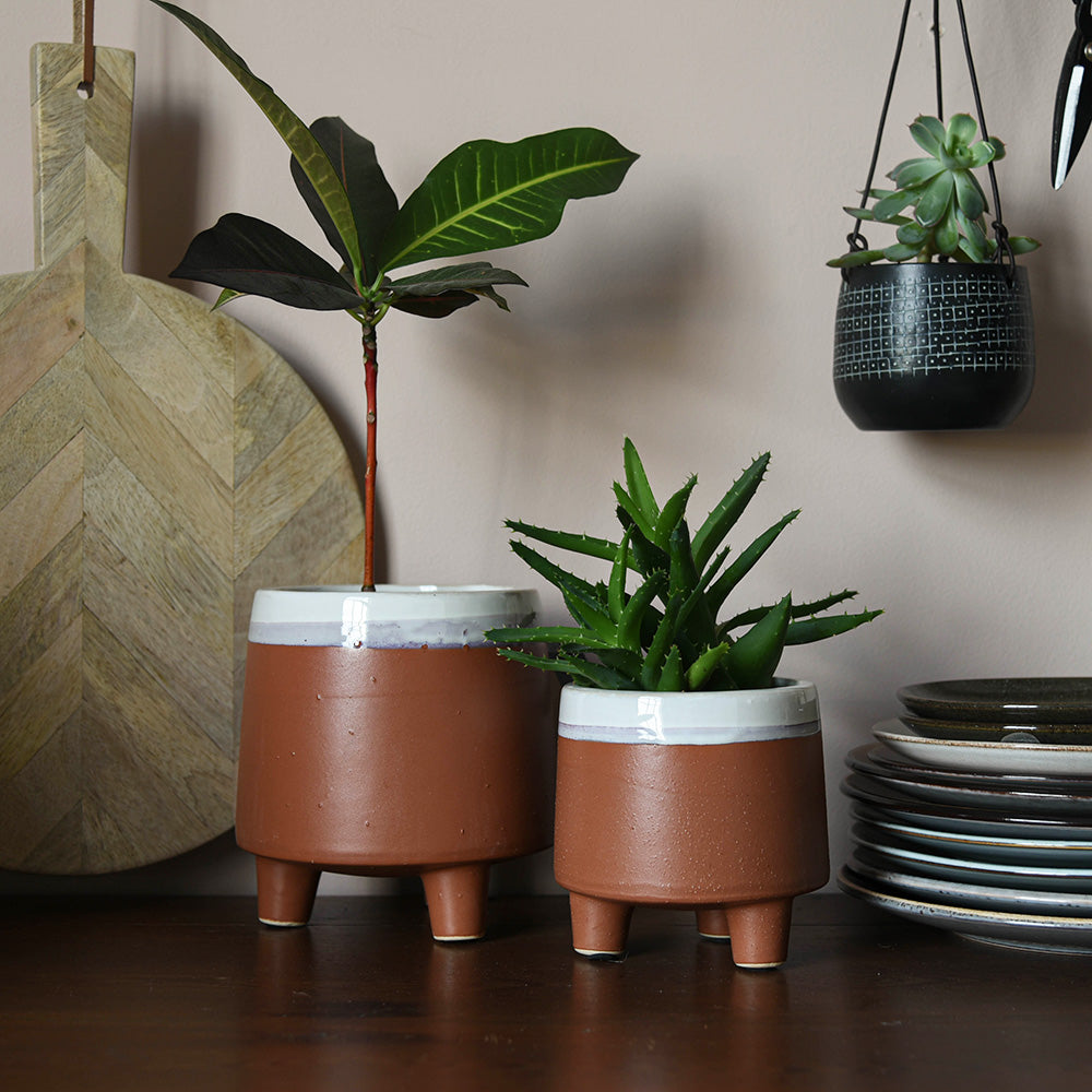 Large (left) and small (right) terracotta and white dipped ceramic plant pots with feet