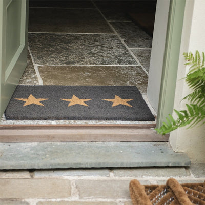 Charcoal coir doormat with three tan stars