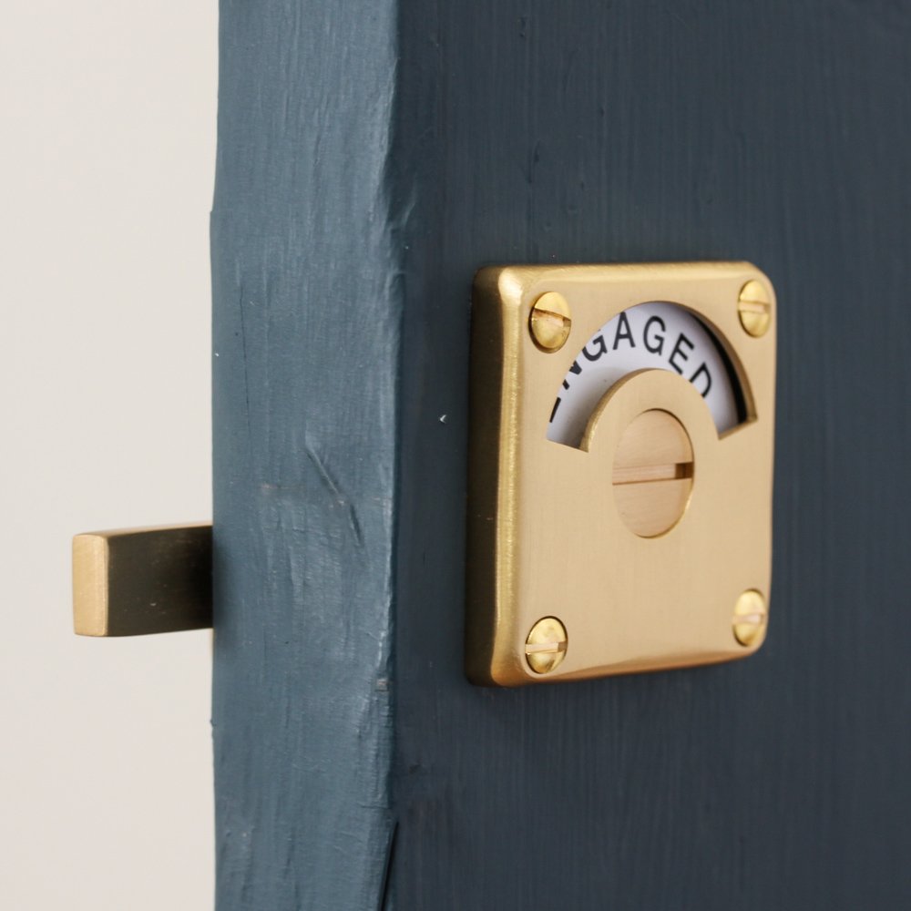 Vacant Engaged Lock in Satin Brass displaying 'engaged'.