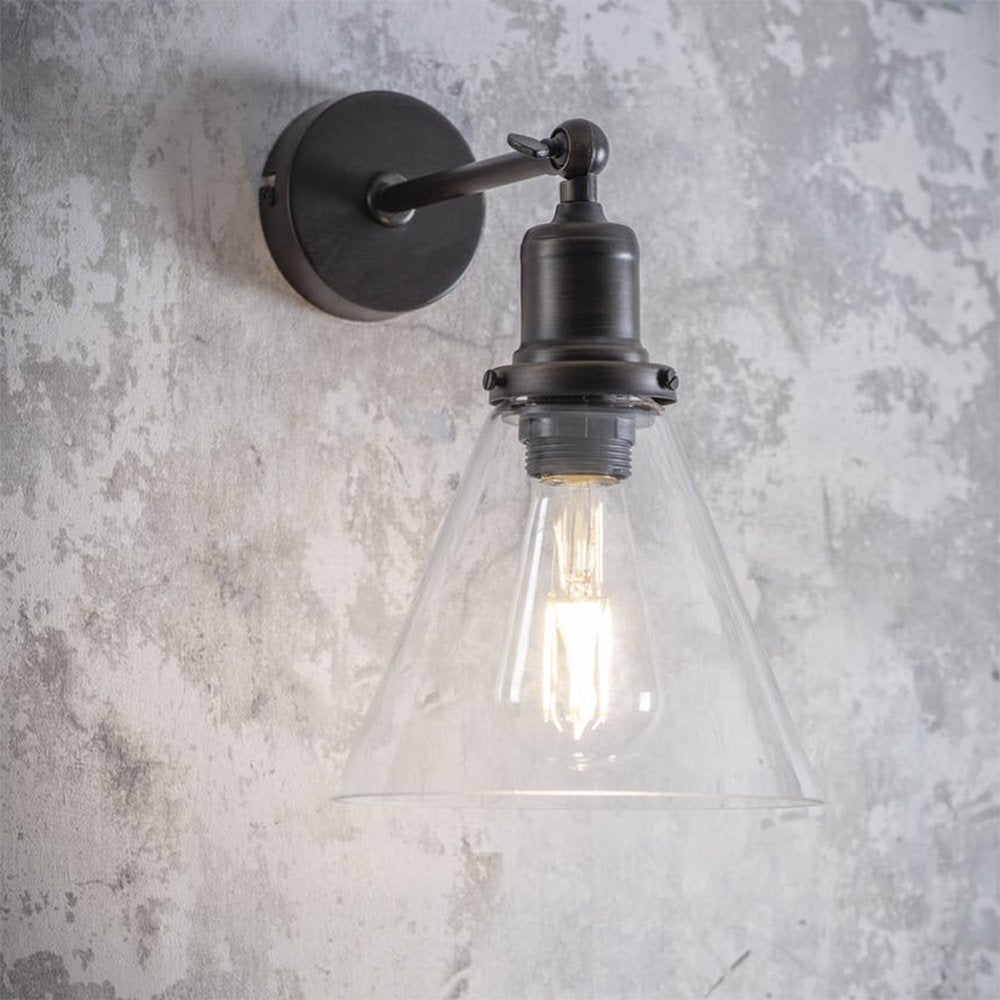 Dark bronze wall light with cone shaped clear glass shade