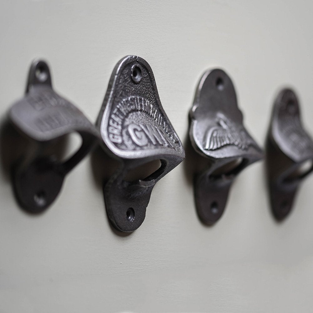 Row of Various Wall Mounted Bottle Openers in Cast Iron Side View