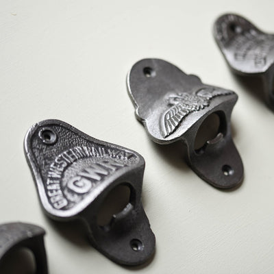 Row of Various Wall Mounted Bottle Openers in Cast Iron
