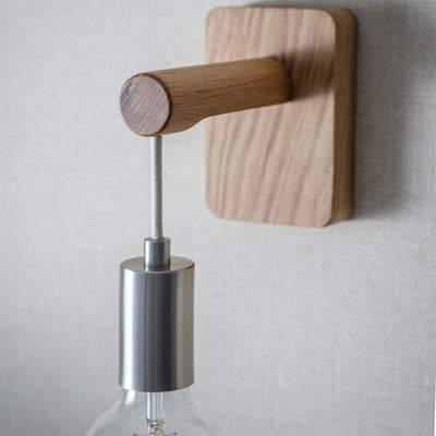 Close up of grain on wooden wall light and satin nickel finish fittings