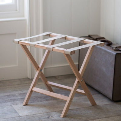 Simple wooden folding luggage rack with cream canvas bands across top to hold suitcases/holdalls